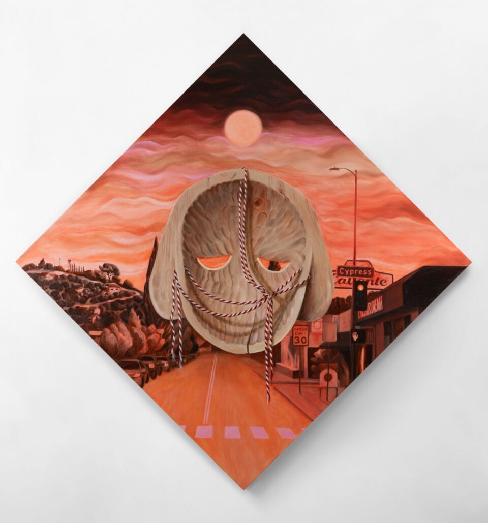 the back of a brown mask atop a pink tinged streetscape