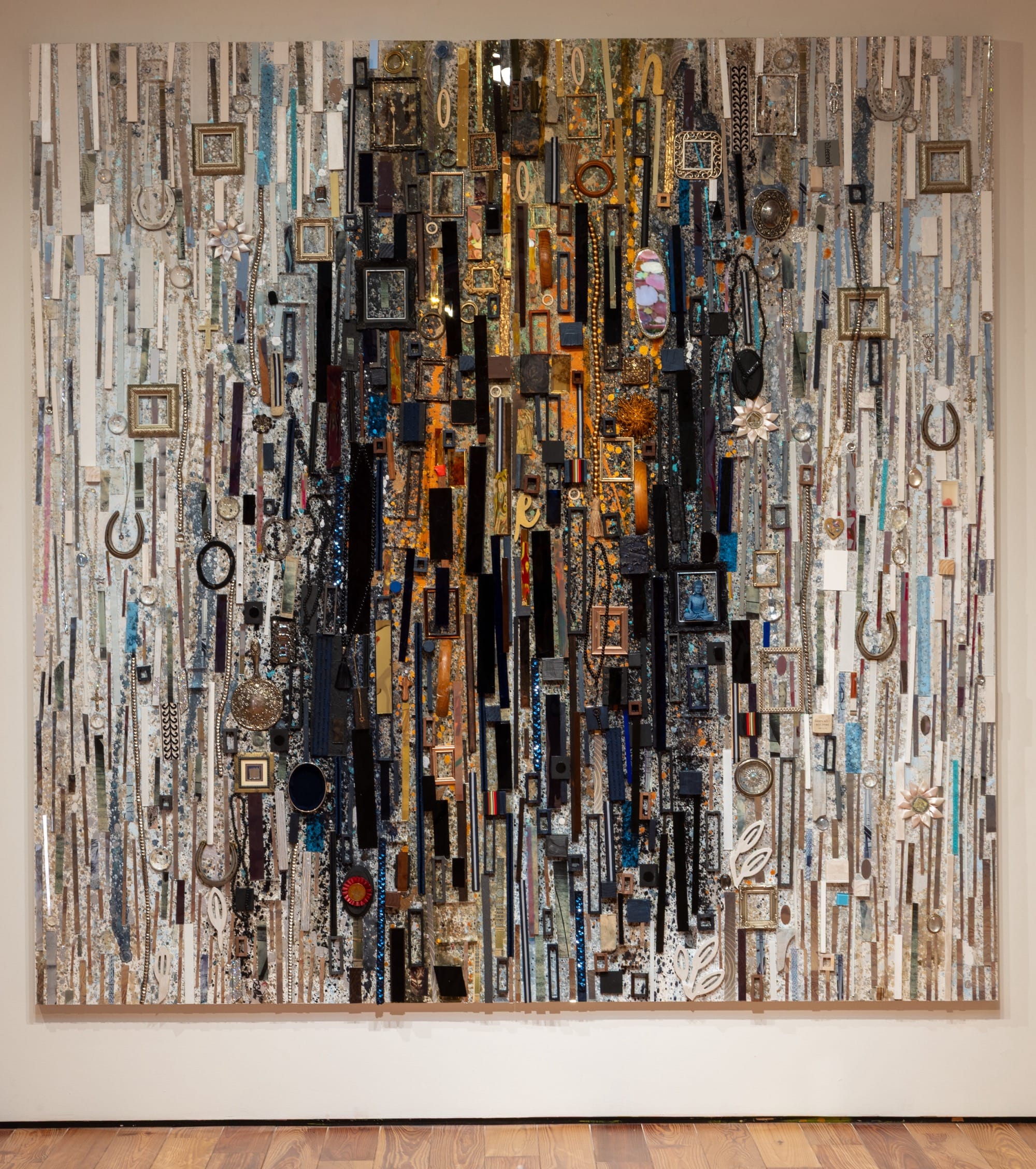 an abstract wall artwork made from assembling numerous pieces of different material