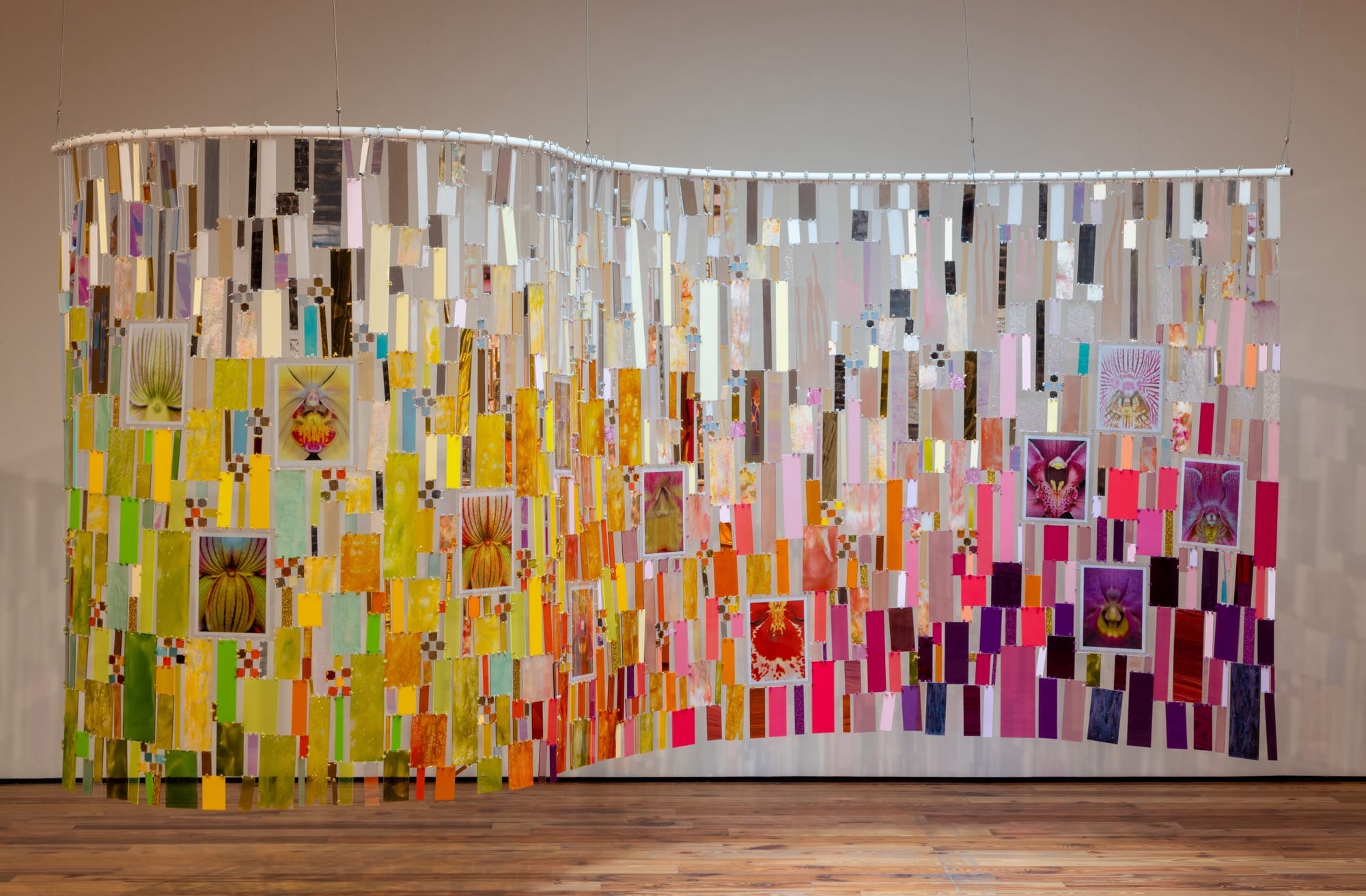 a colorful, suspended mixed-media tapestry installation