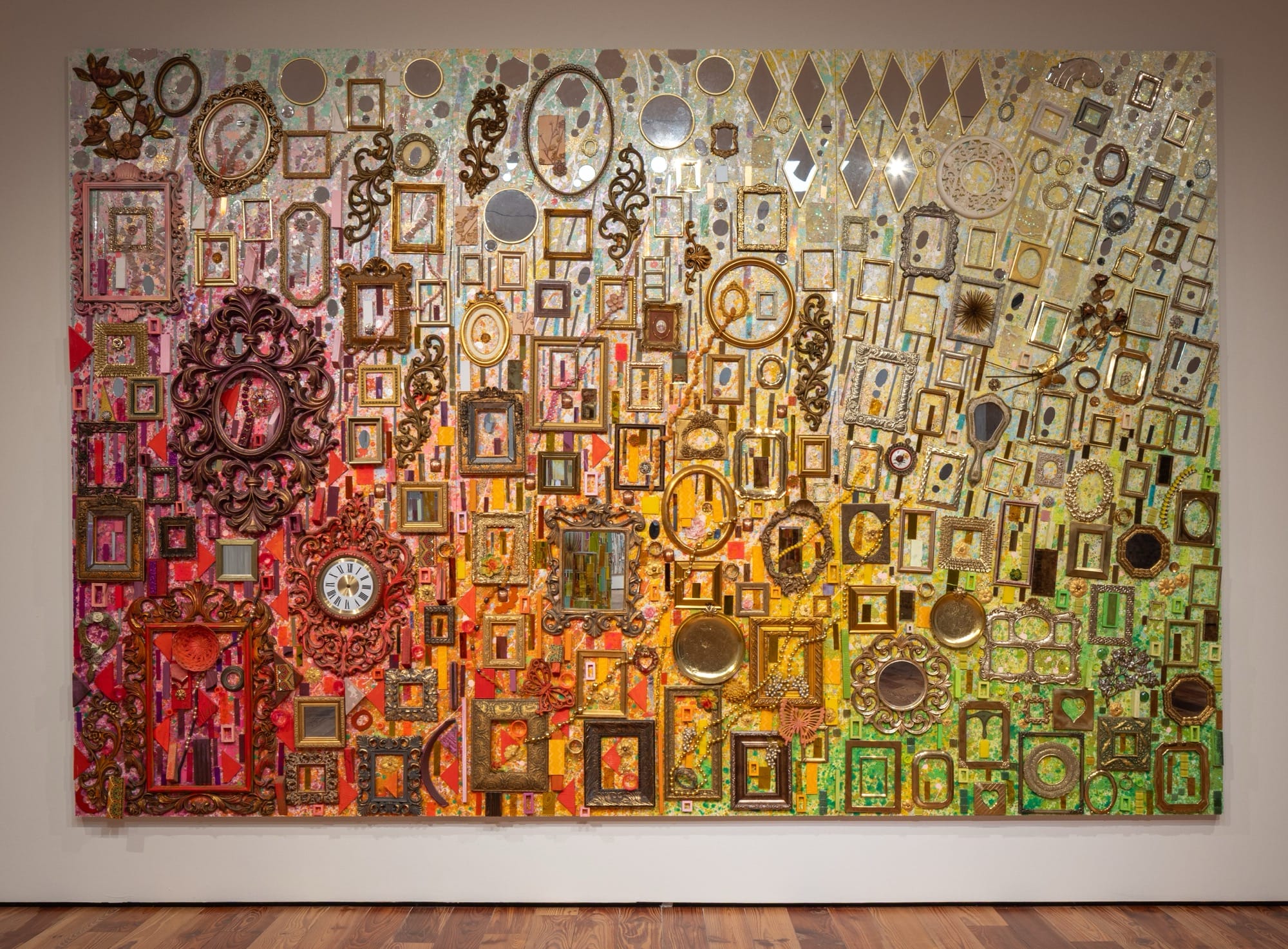 an assemblage made from tapestry elements and dozens of picture frames