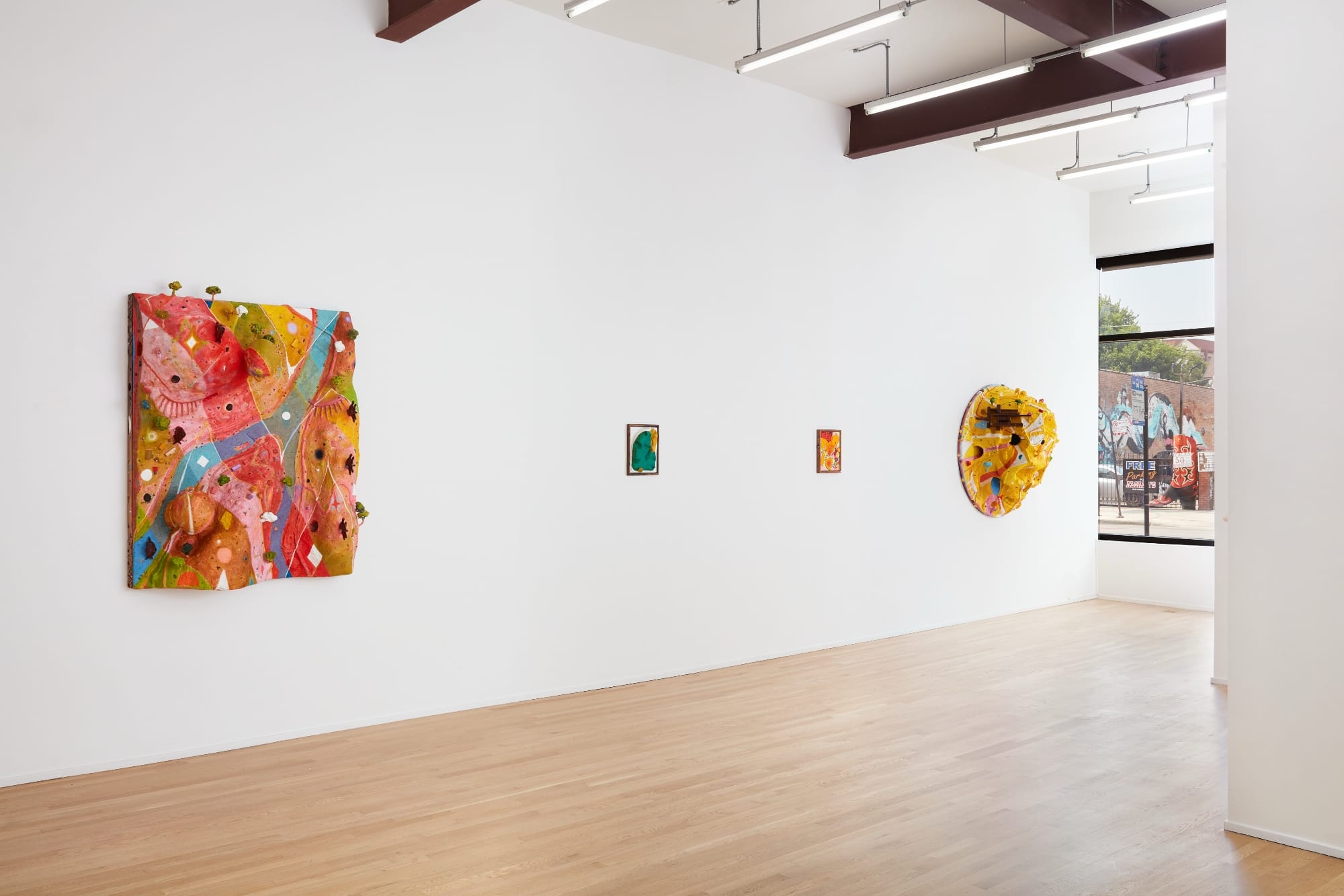 an installation view of sculptural paintings in a gallery