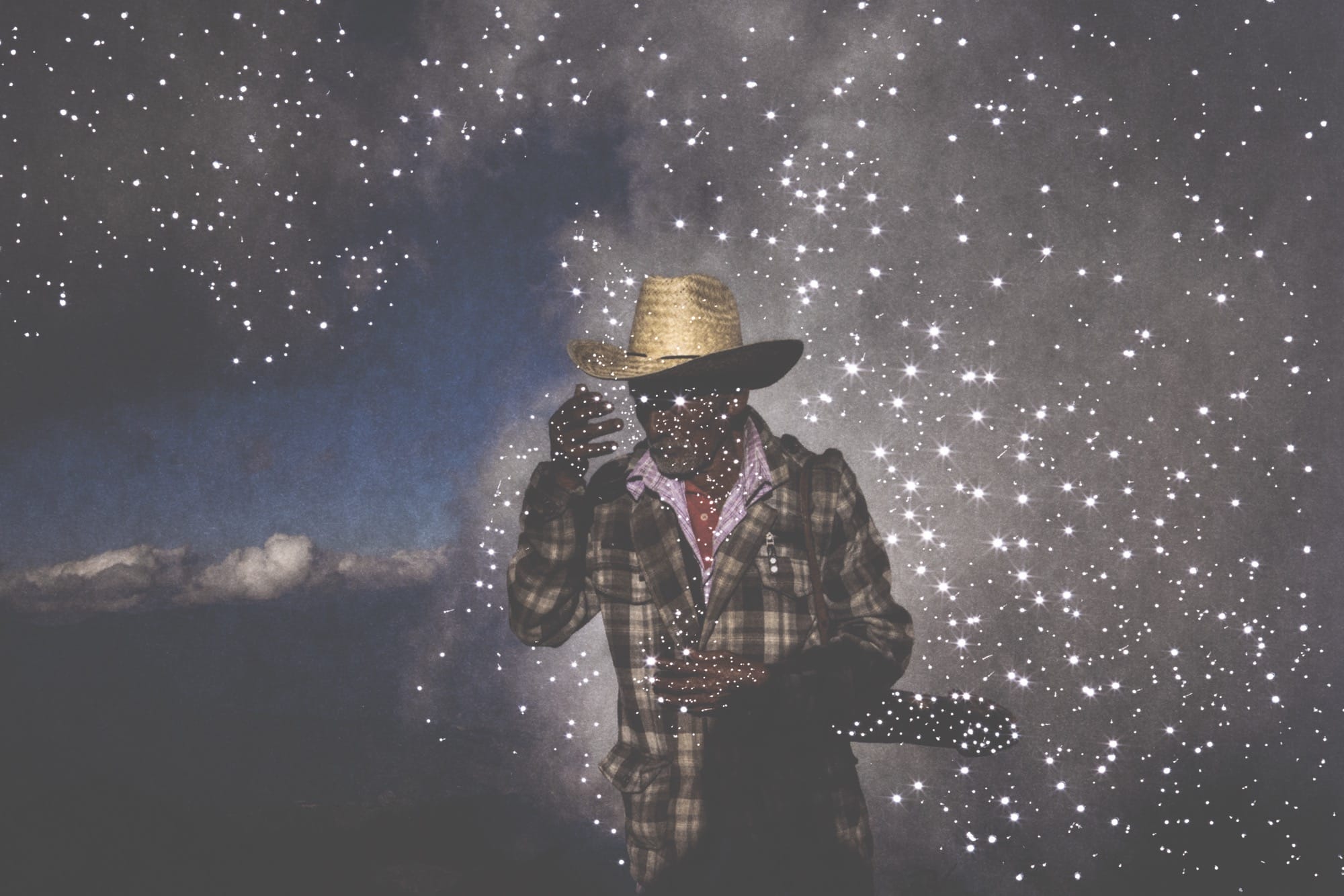 small holes pierce a dark photo of a man