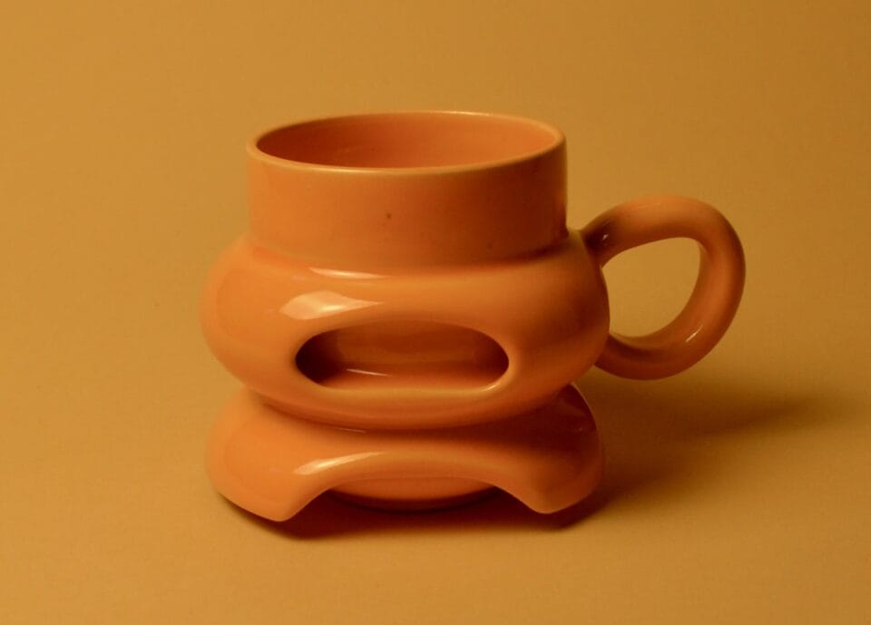a bright orange geometric mug