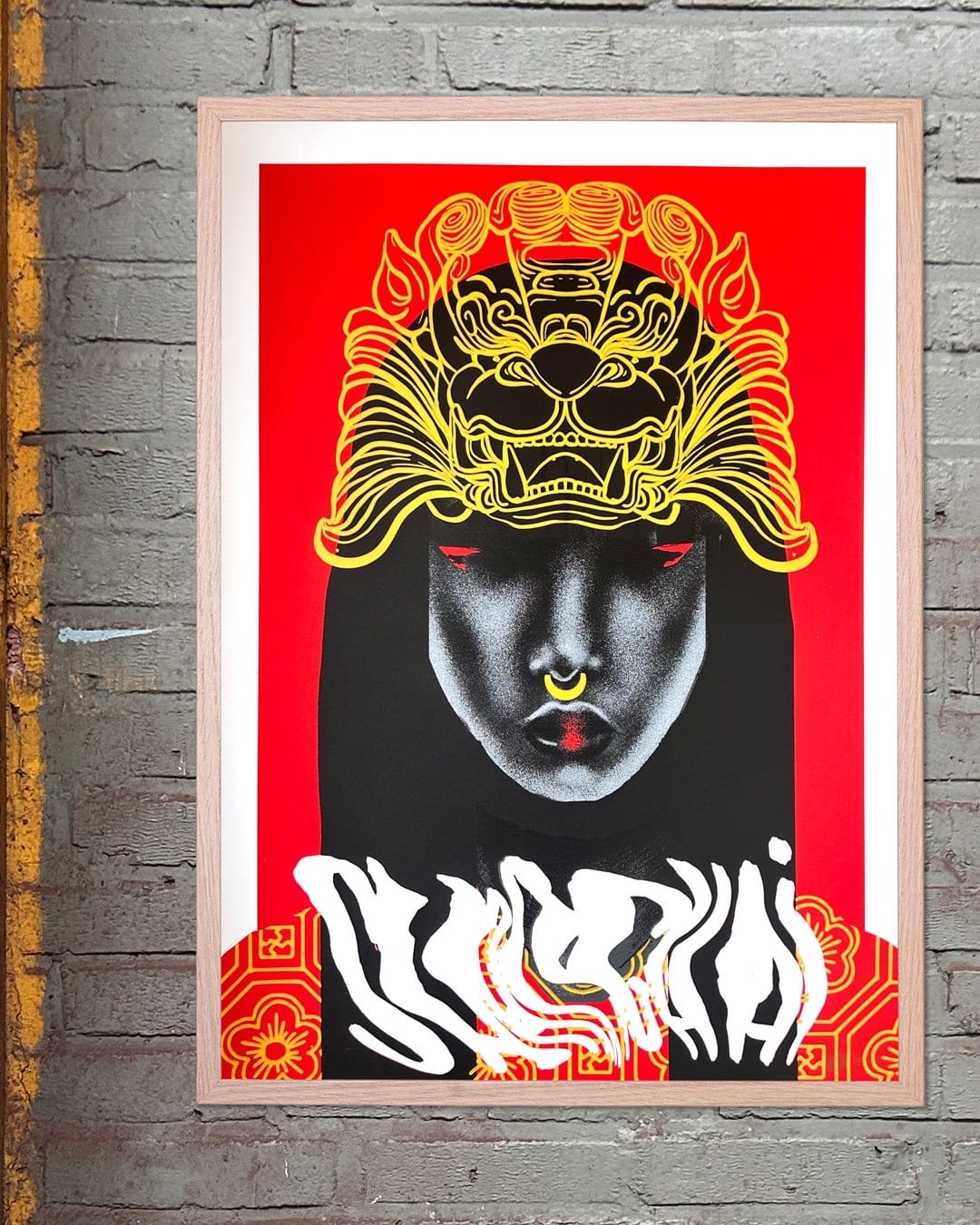 a print of a woman with a fudog crwon in gold and red eyes on a red background