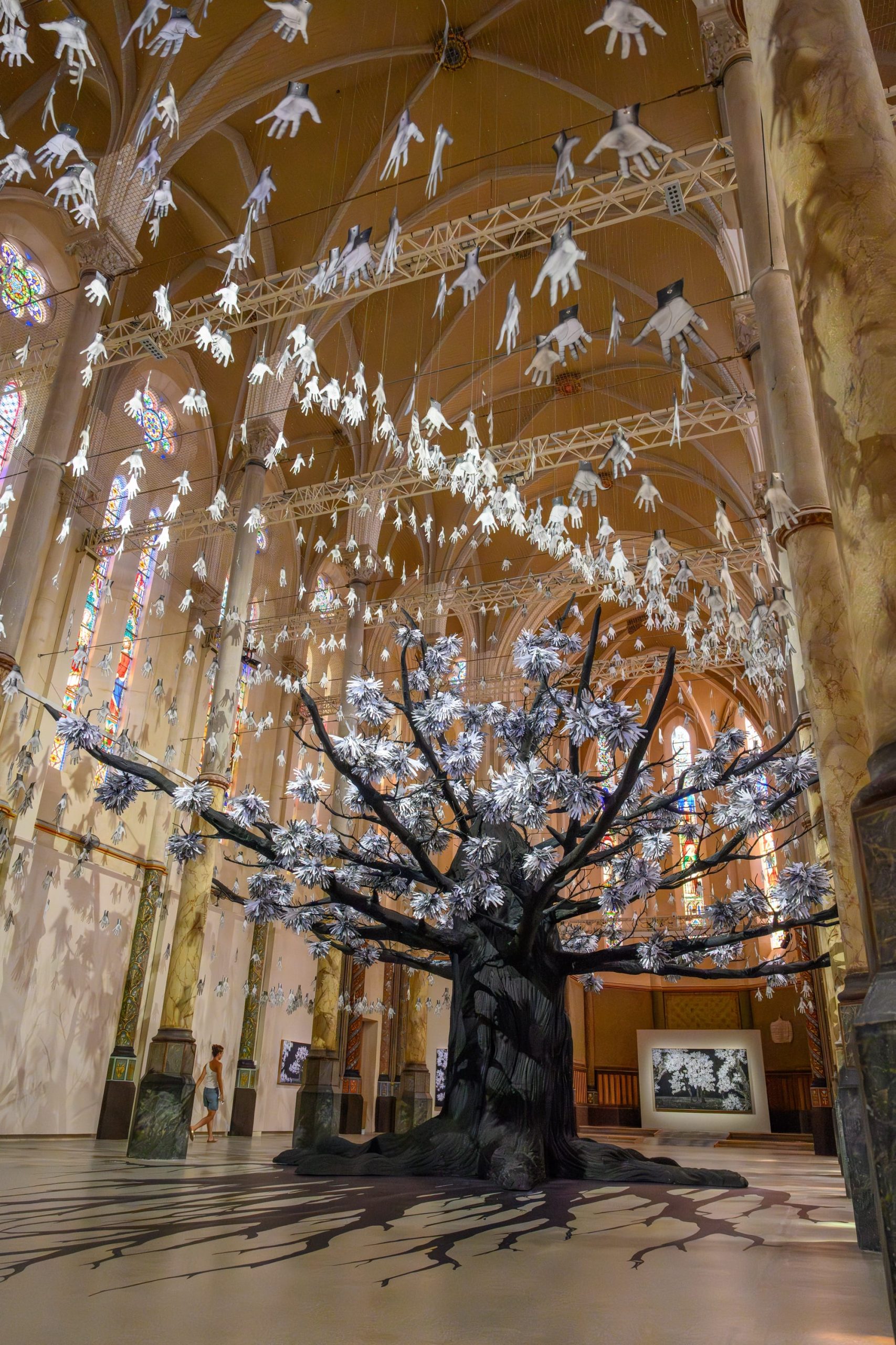 a tree installation with leaves made of hands