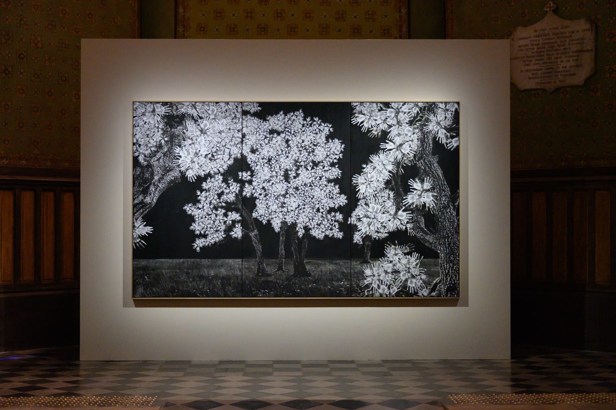 a wall work of a tree with leaves made of hands