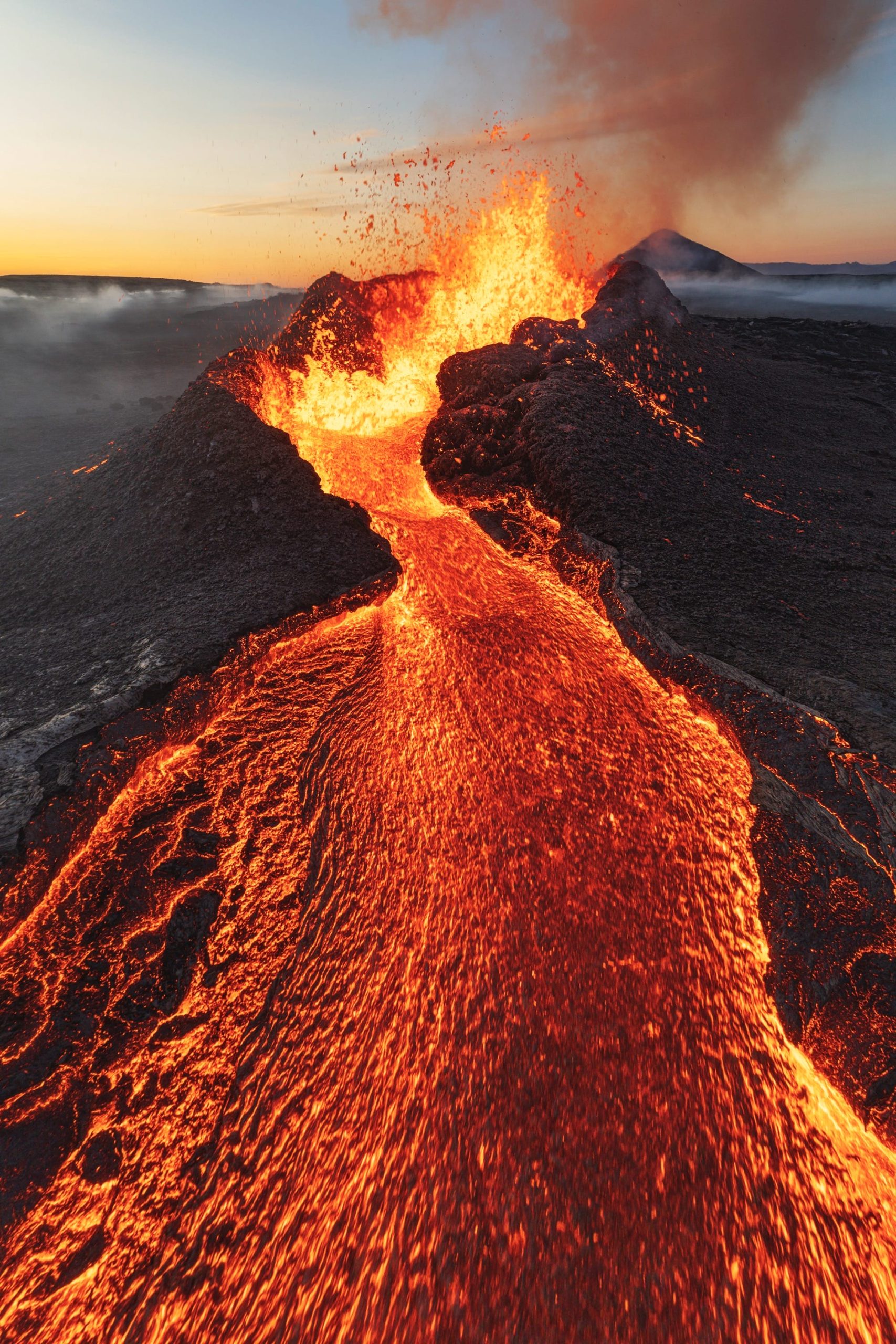 an aerial image of an erupting volcano with lava