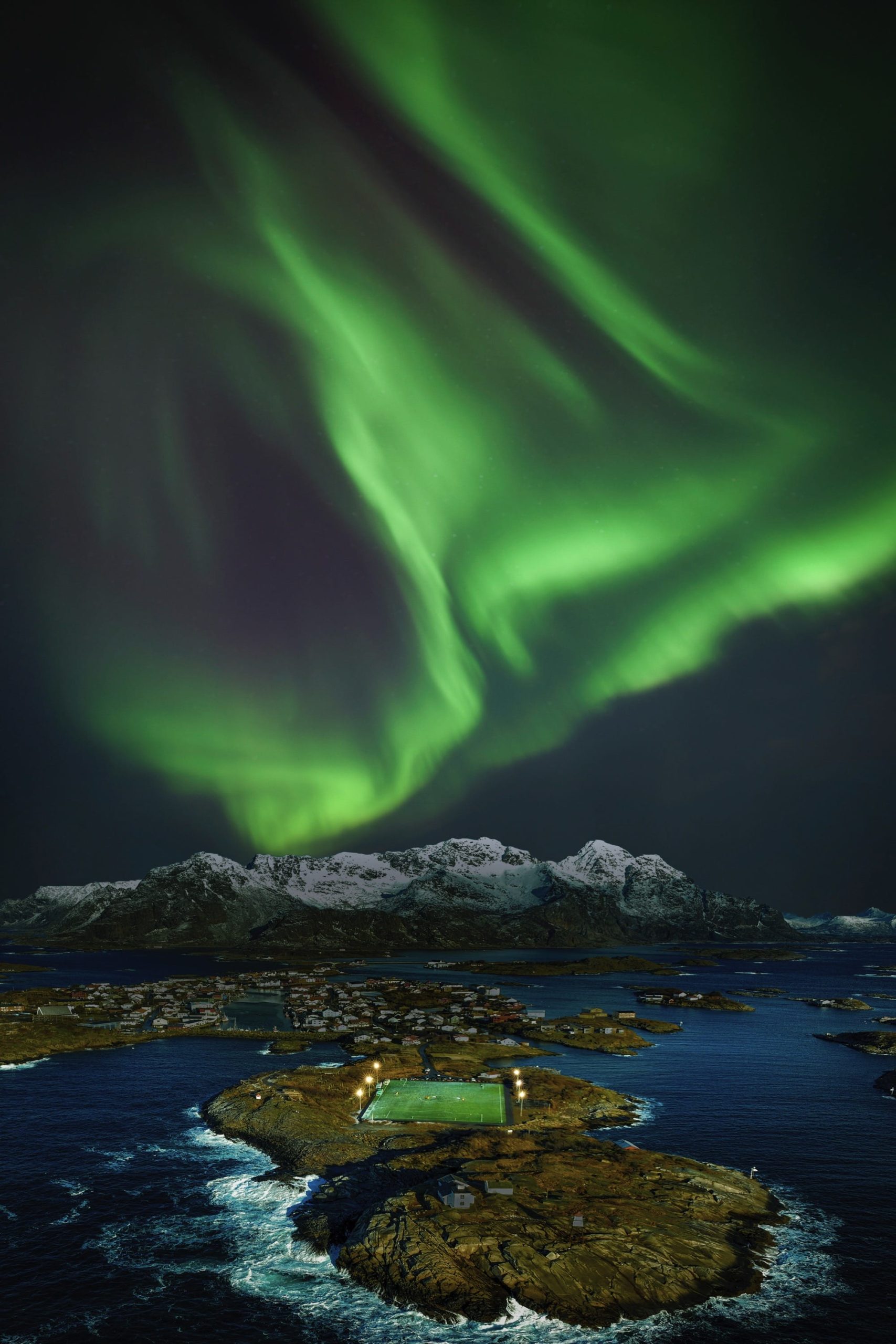 a football field in the arctic under northern lights