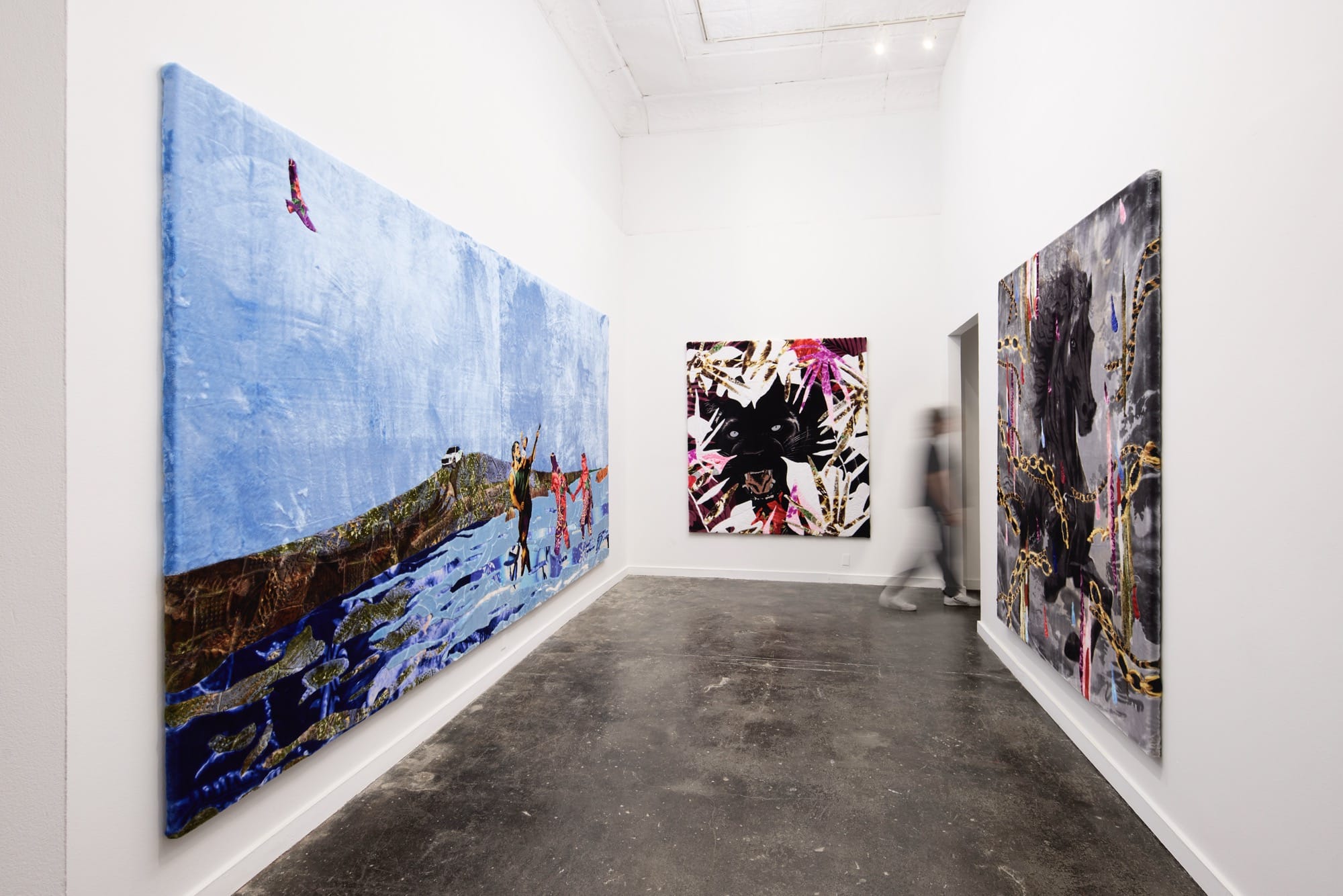 an installation view of three large-scale paintings in a small white-walled gallery space