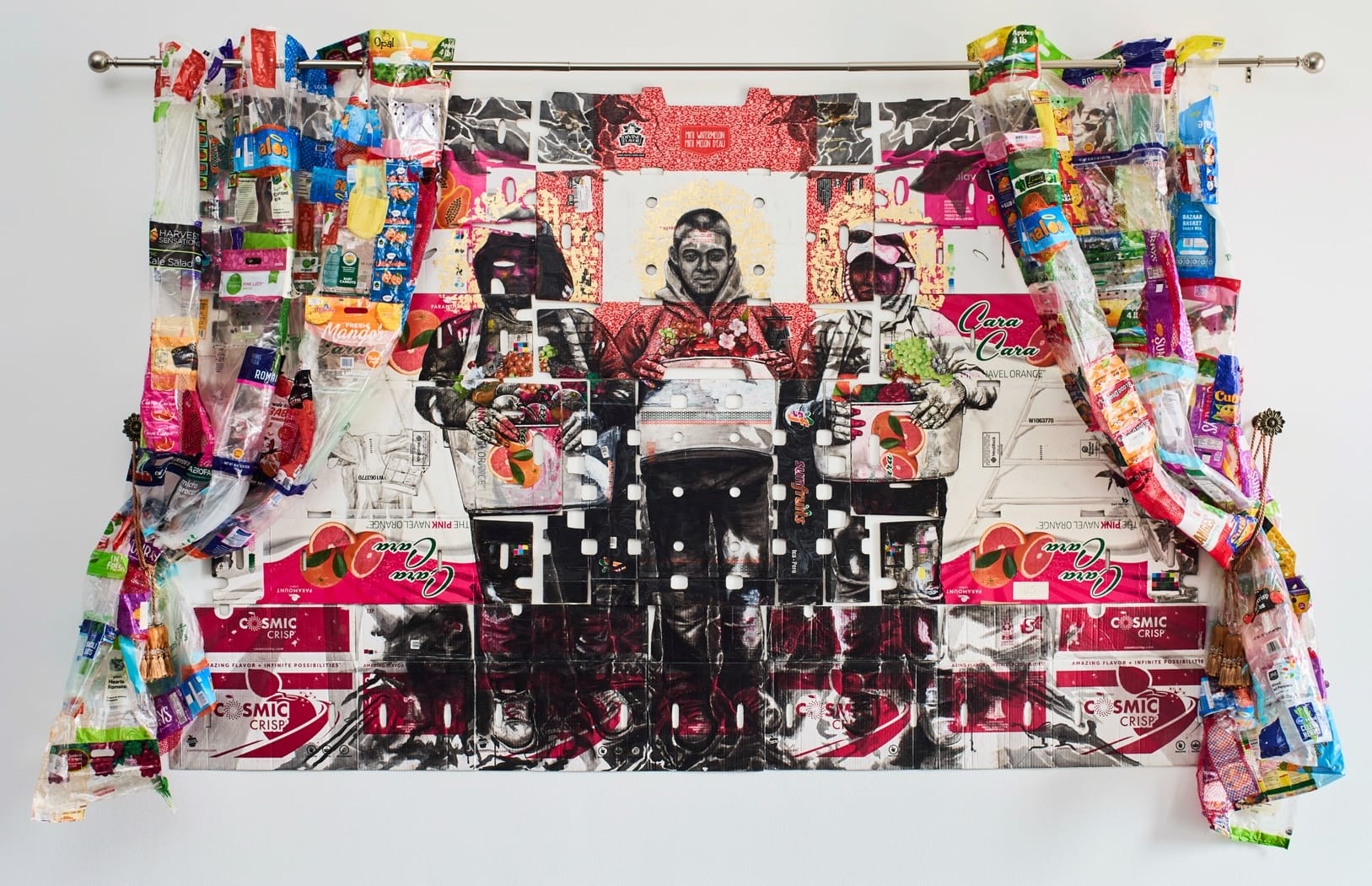 a large-scale assemblage portrait of three agricultural laborers on produce boxes, situated within drapes made of reclaimed plastic