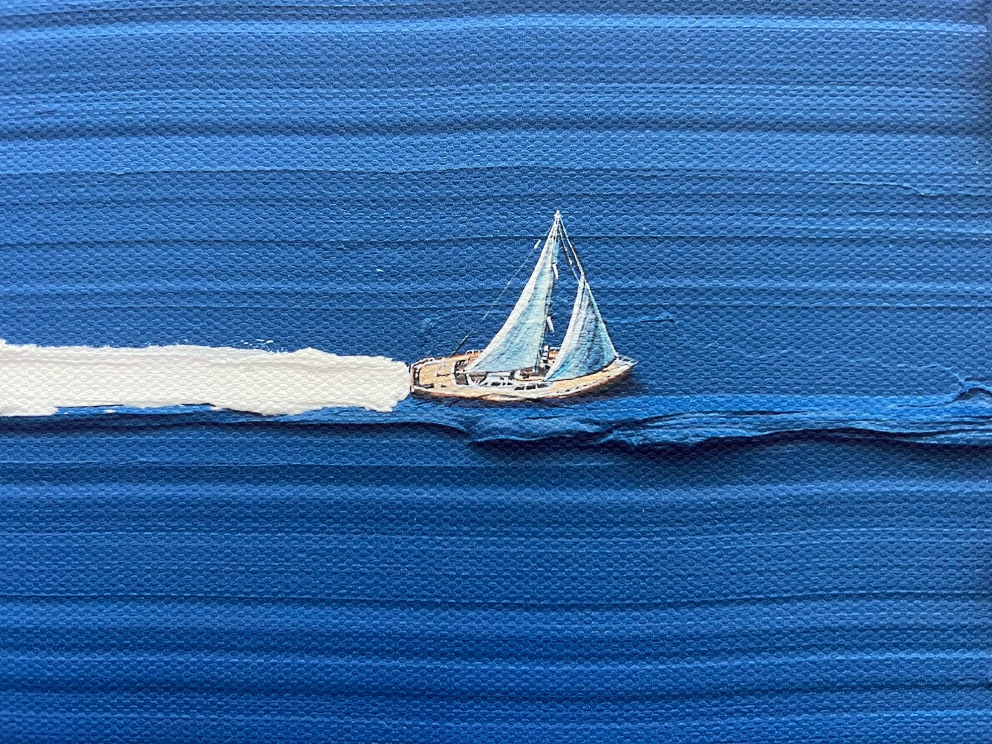 a small ship sailing on blue impasto
