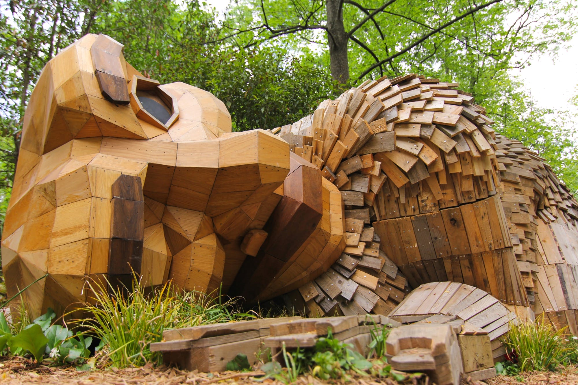 a giant wood troll with its ear to the ground
