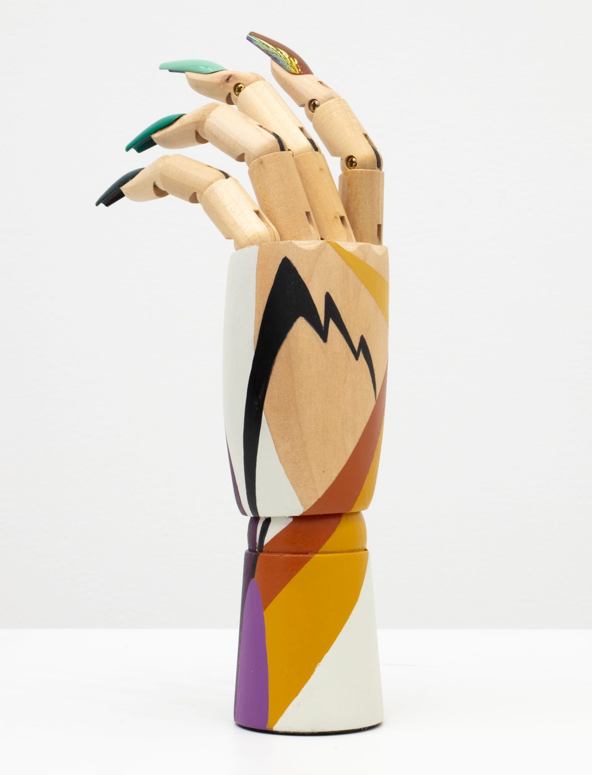 a wooden hand mannequin painted with fake nails