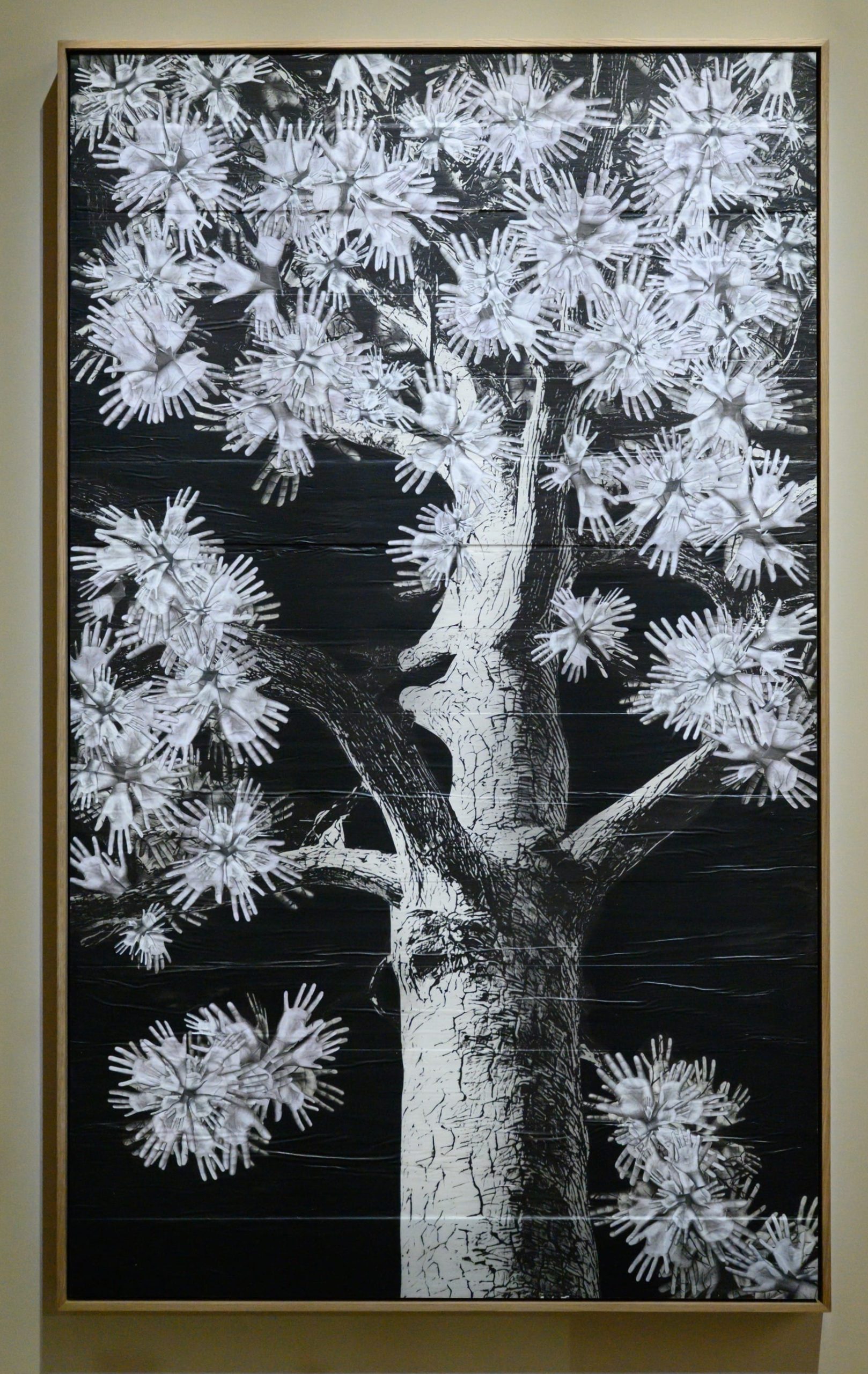 a wall work of a tree with leaves made of hands