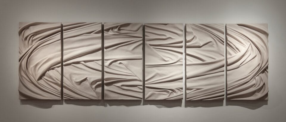 a six-panel wall installation of white drapery folds