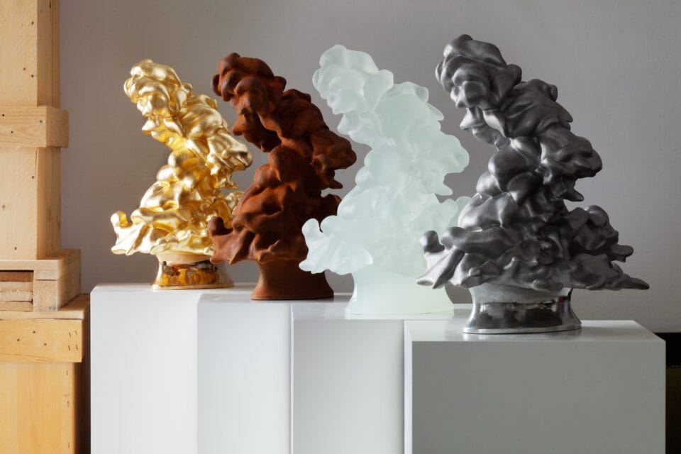 a series of four cumulus cloud sculptures in different materials and colors
