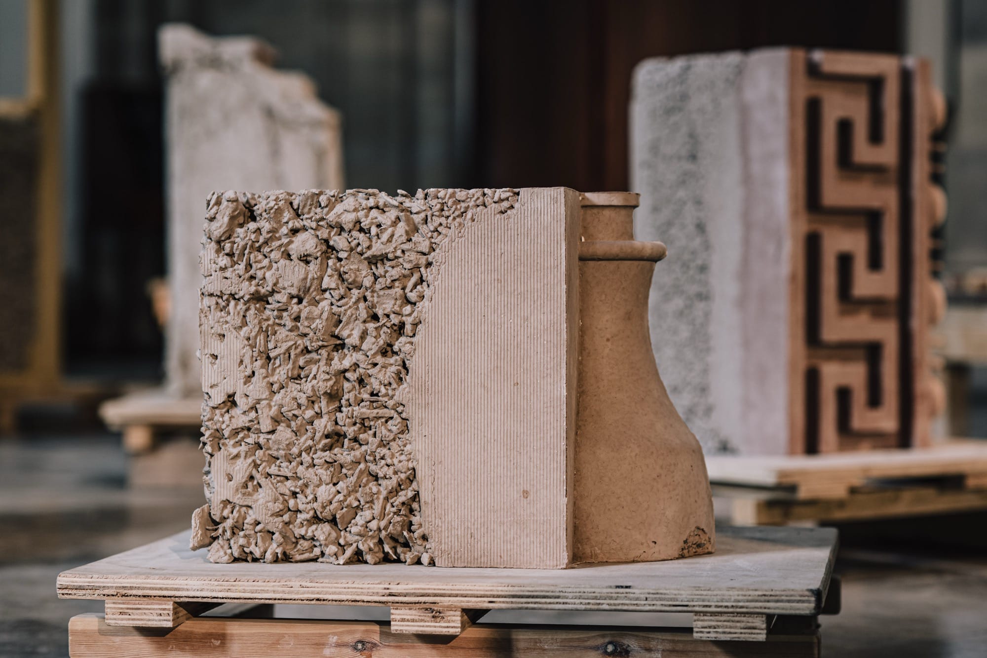 a detail of a sculptural installation with numerous plaster and stone objects