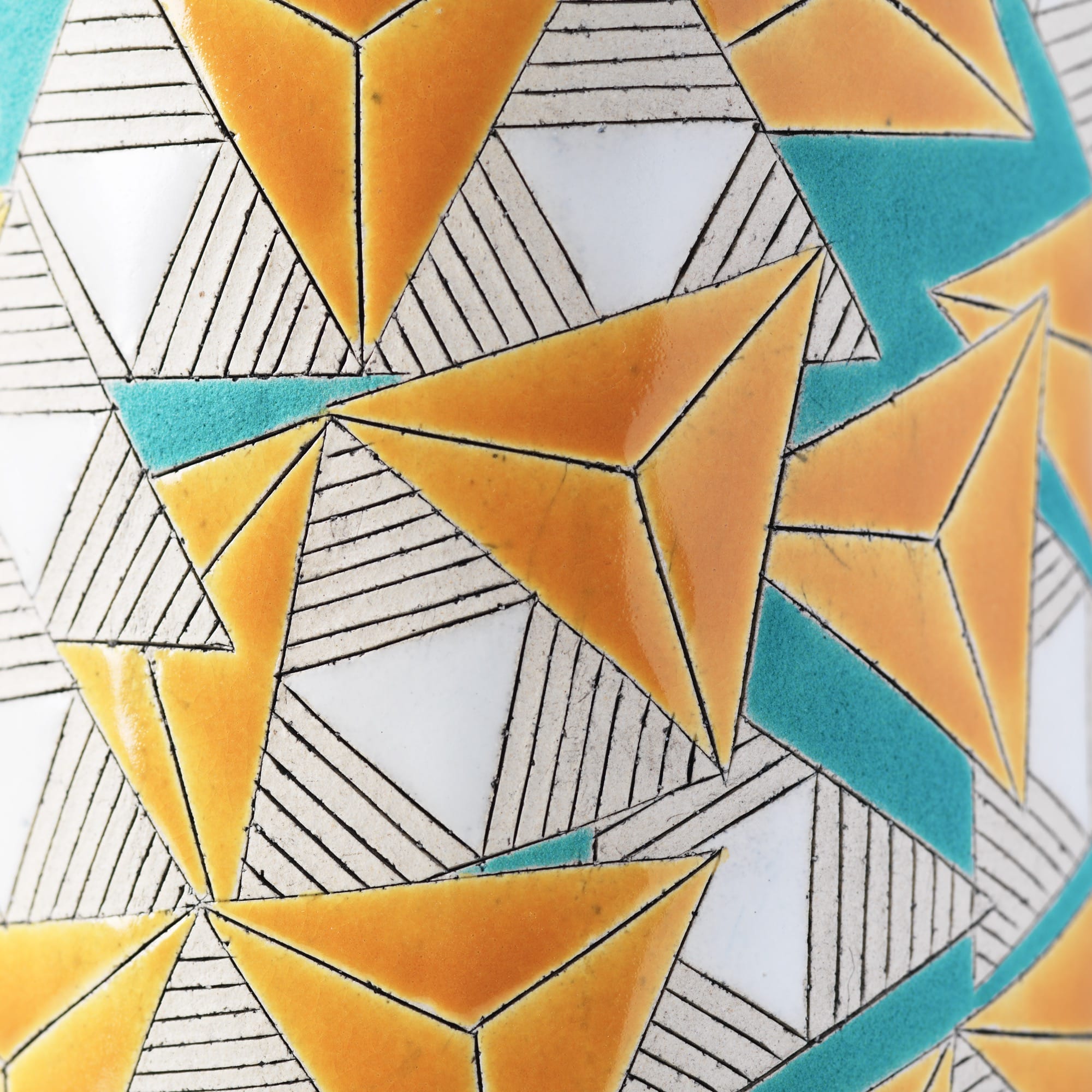 Detail of a geometric pattern in white, orange, and teal