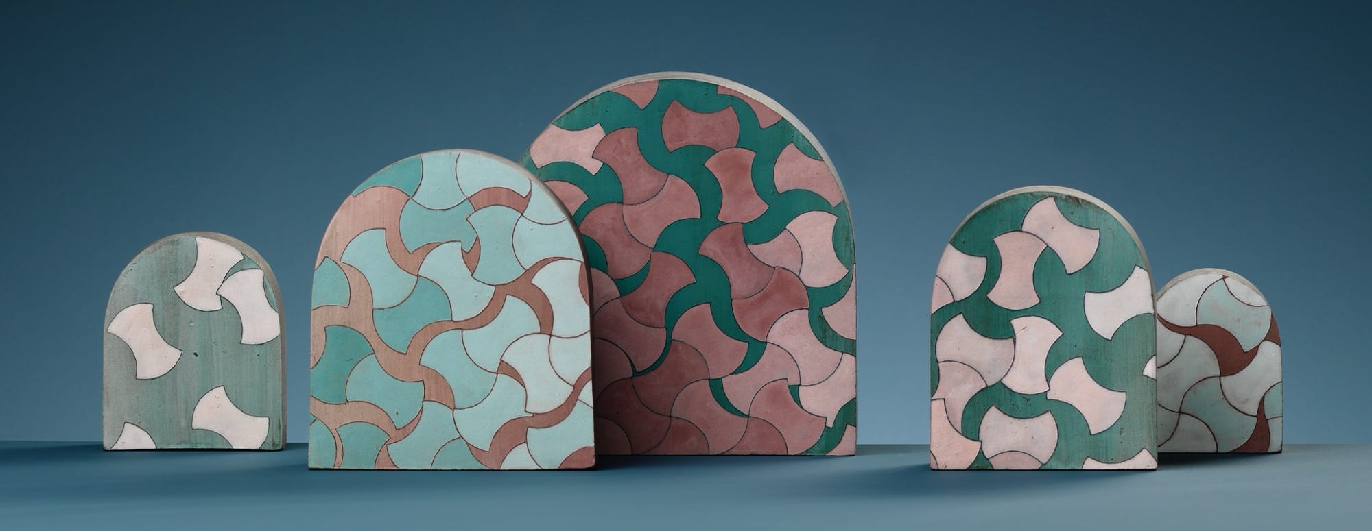 a series of patterned ceramic tablets with round tops