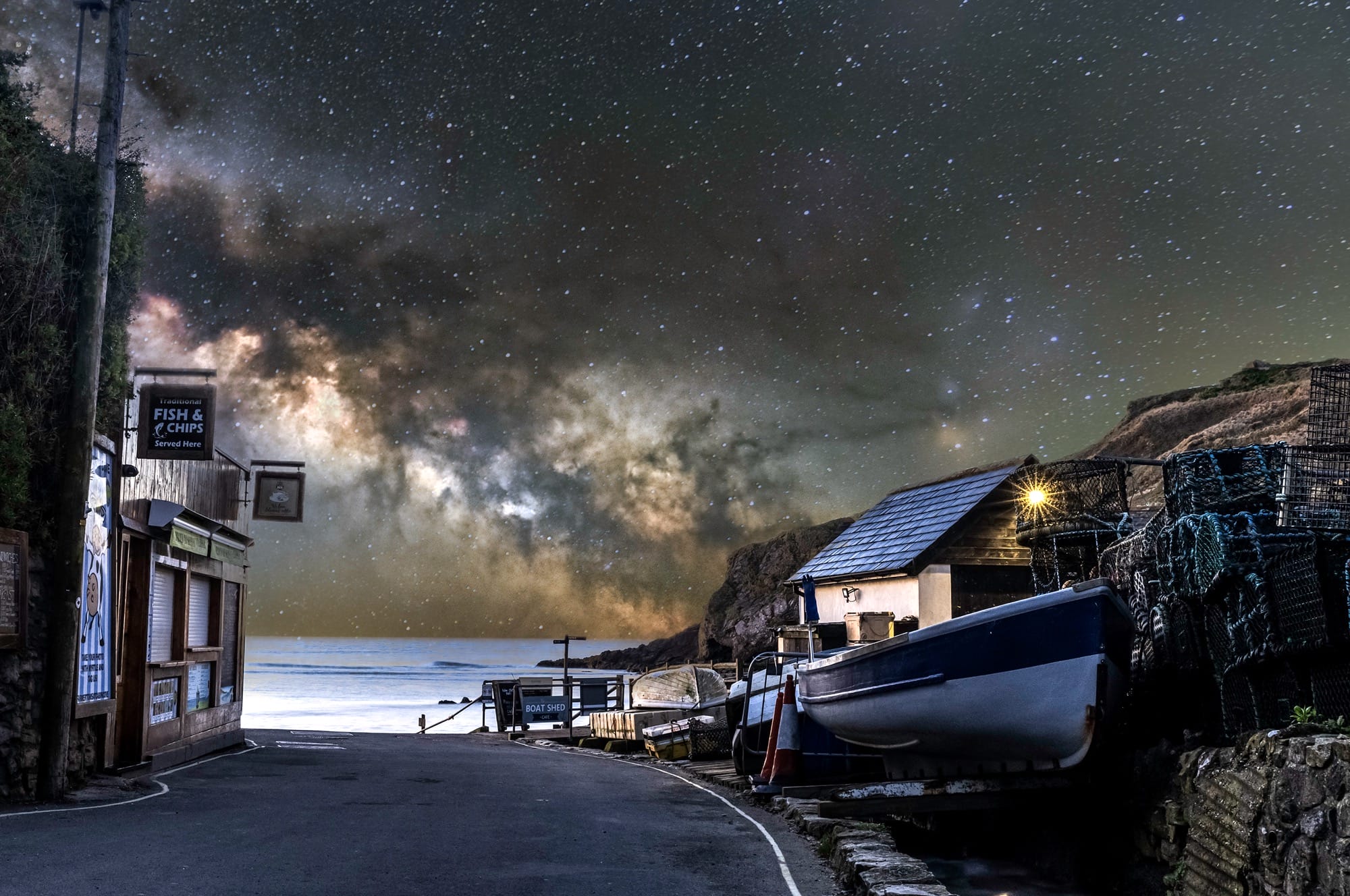 the Milky Way photographed at the end of a fishing village street